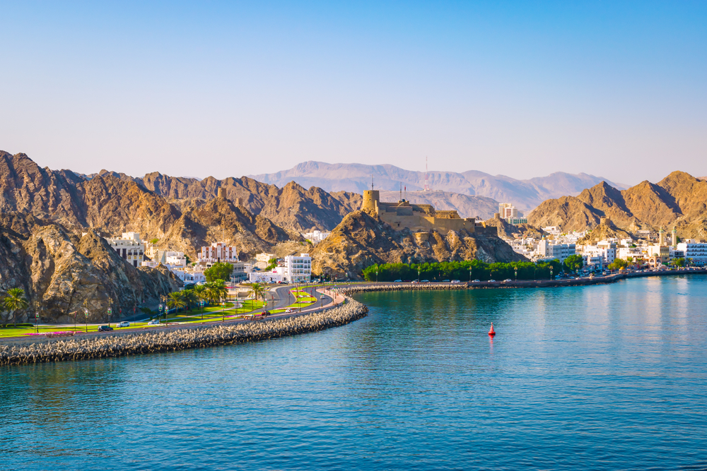 Muscat cityscape with Omani architecture and mountains in the background