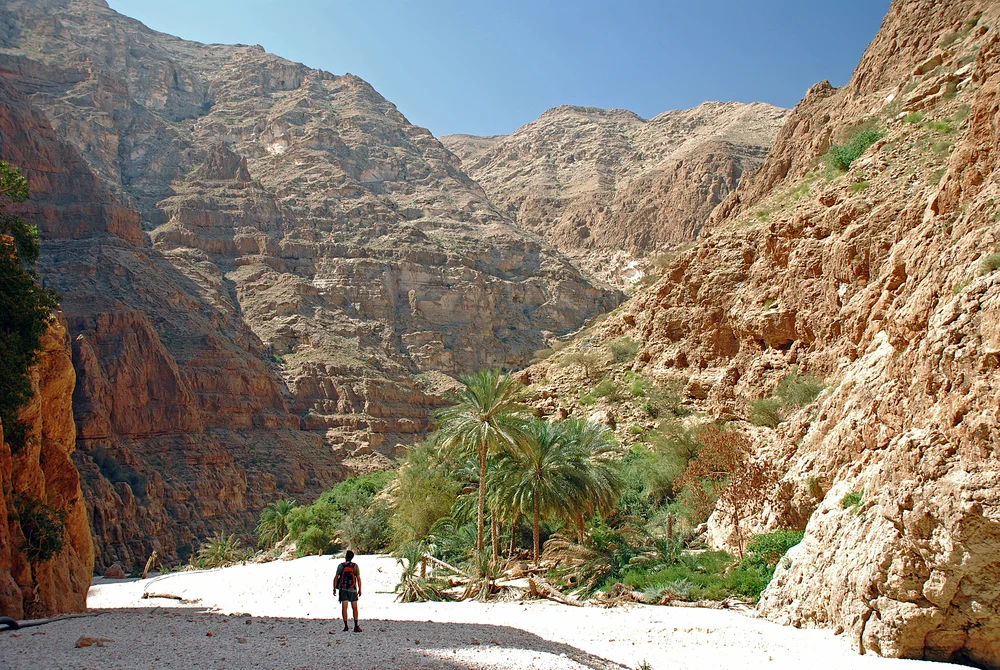 Wadi Shab in Oman with traveler exploring the wadi