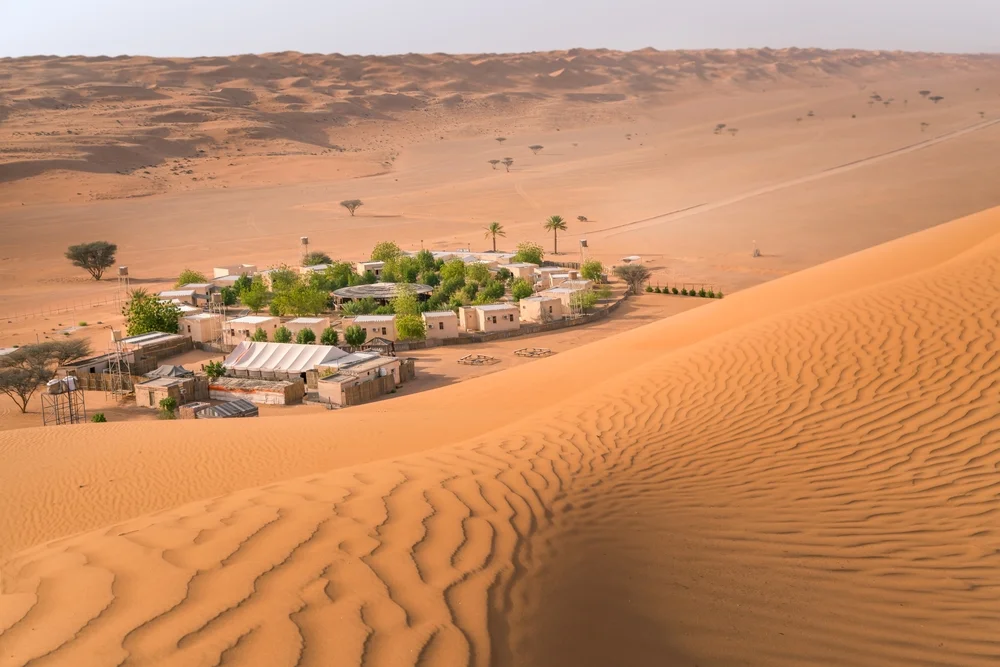 Small,Camp,With,Trees,In,The,Middle,Of,Arabian,Desert.